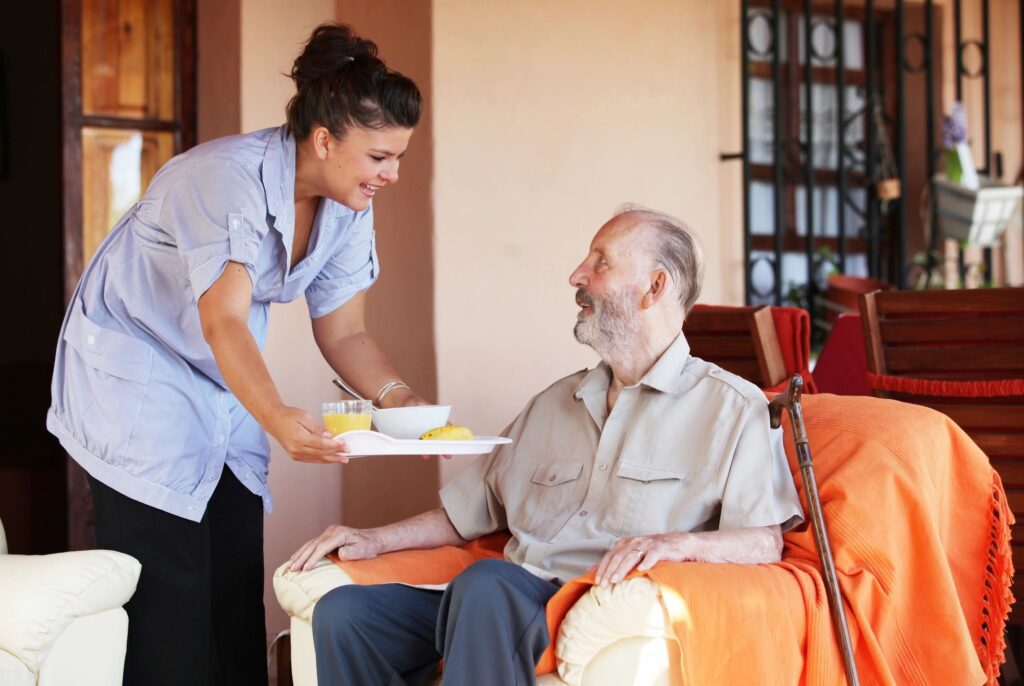 Caregiver serving meal